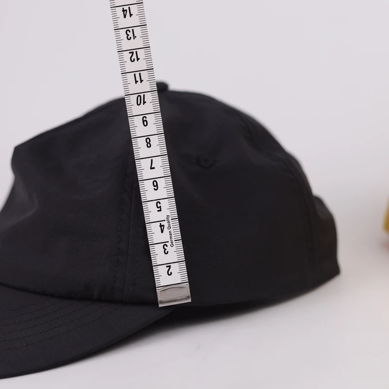 Low-profile cap crown height measured on a physical sample